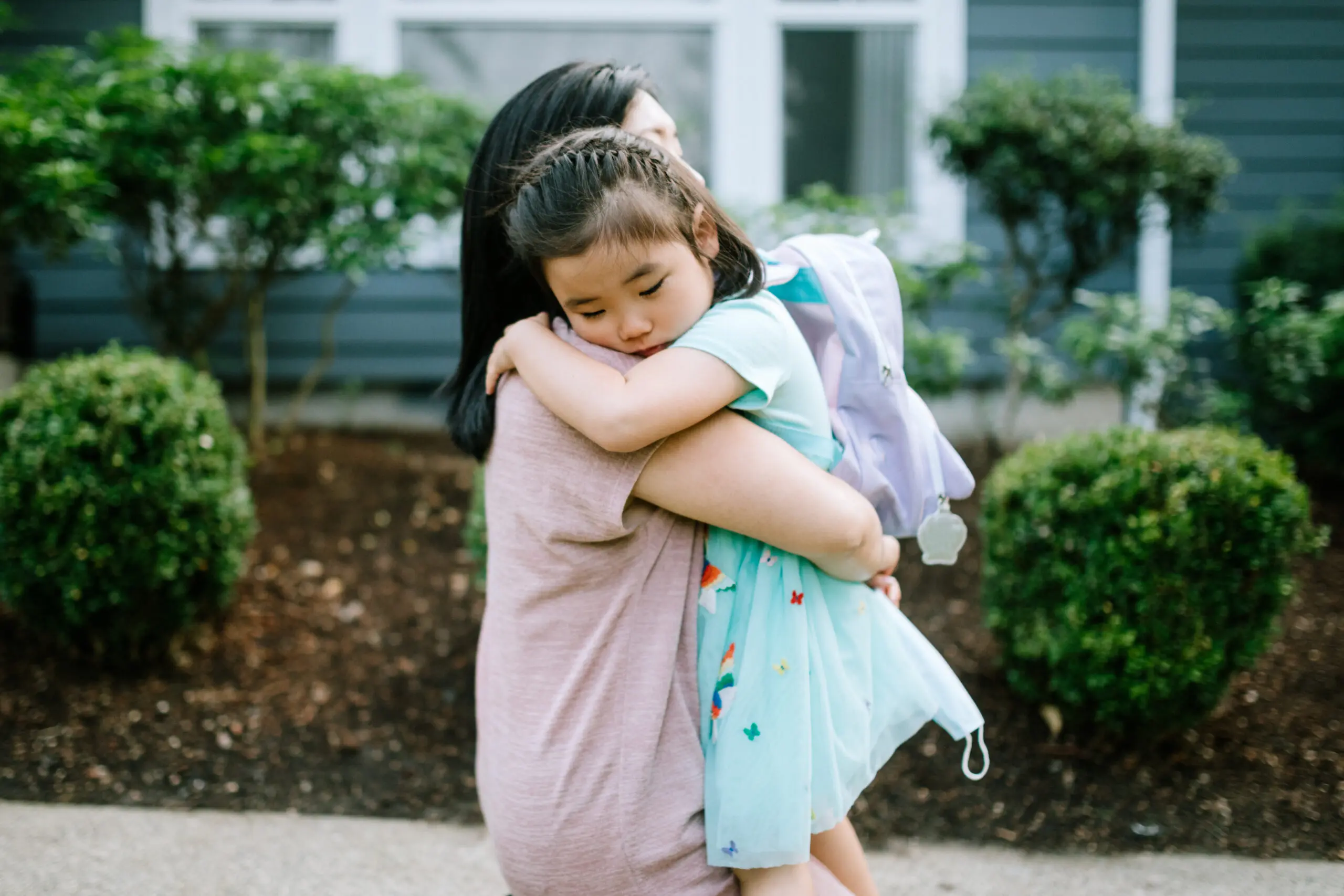 Girl Hugs Her Mother On First Day of School