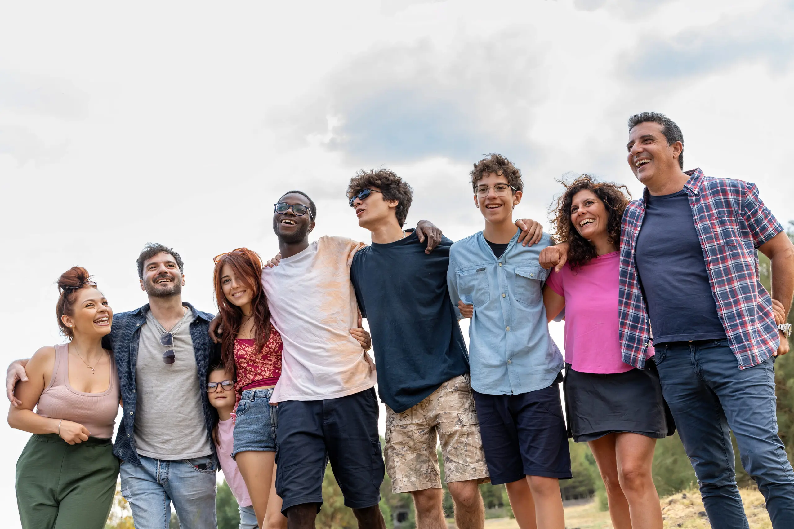 Diverse group of friends enjoying outdoor gathering, multicultural community celebrating together